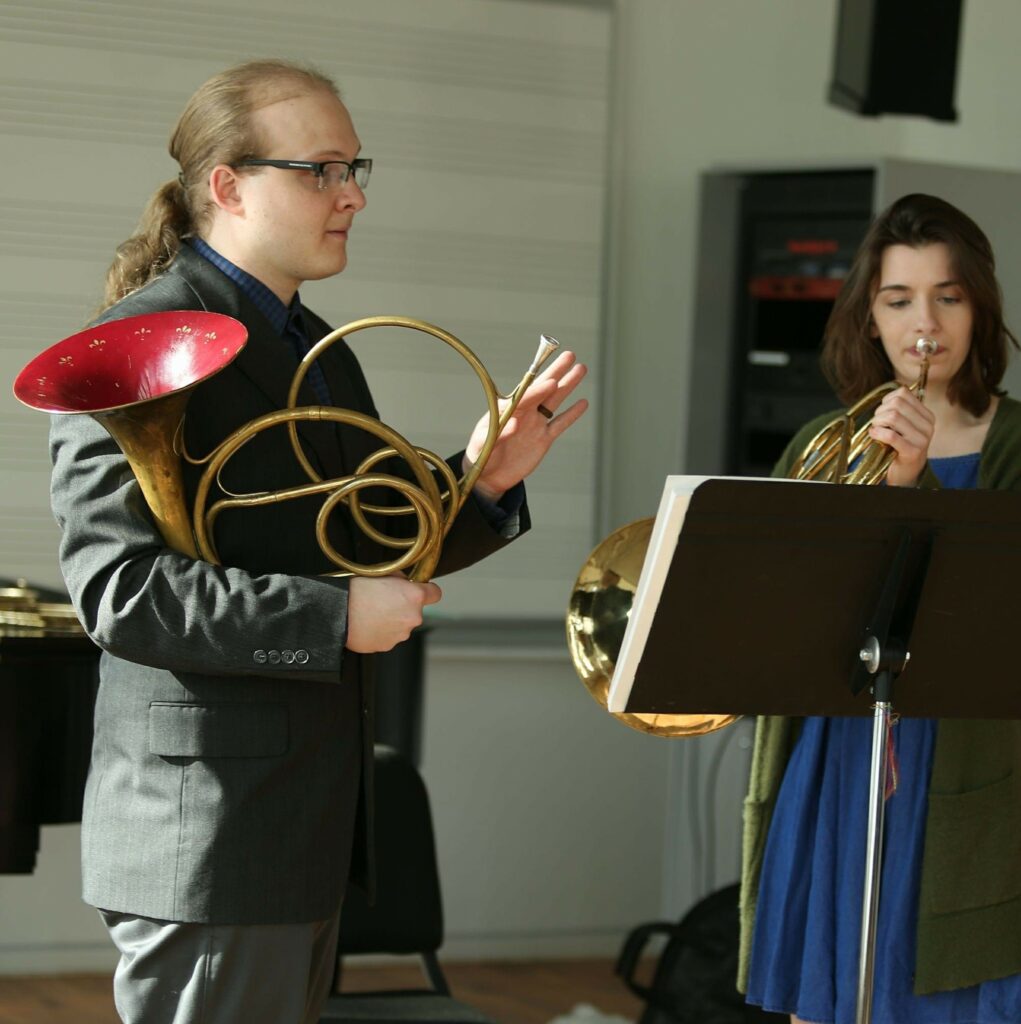 James teaching a student horn one-on-one